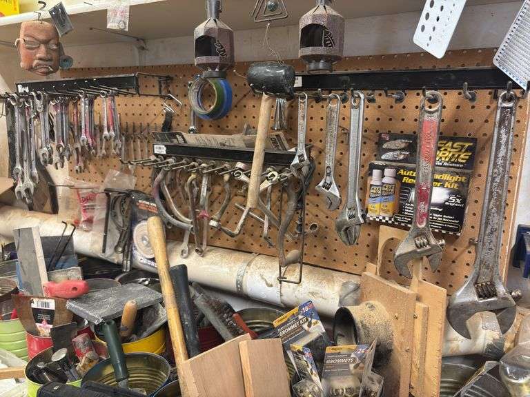 Large quantity of hand tools on top of bench