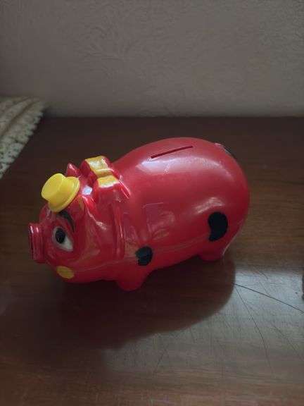 Three piggy banks and one pig with Grand Rapids Minnesota advertising