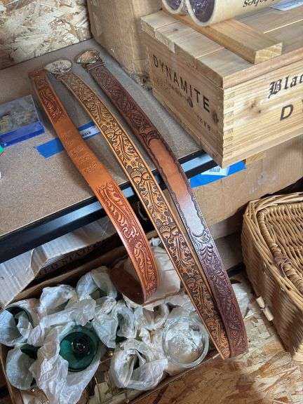 Three stamped leather belts one with the name Kathy size 32 and 2 belt buckles