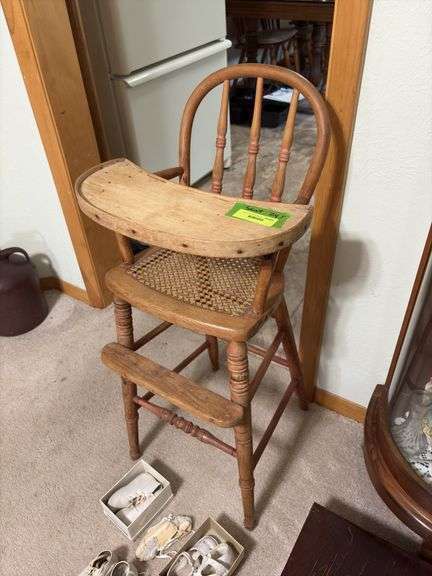 Antique wooden high chair and baby shoes Per Seller dates back to 1877