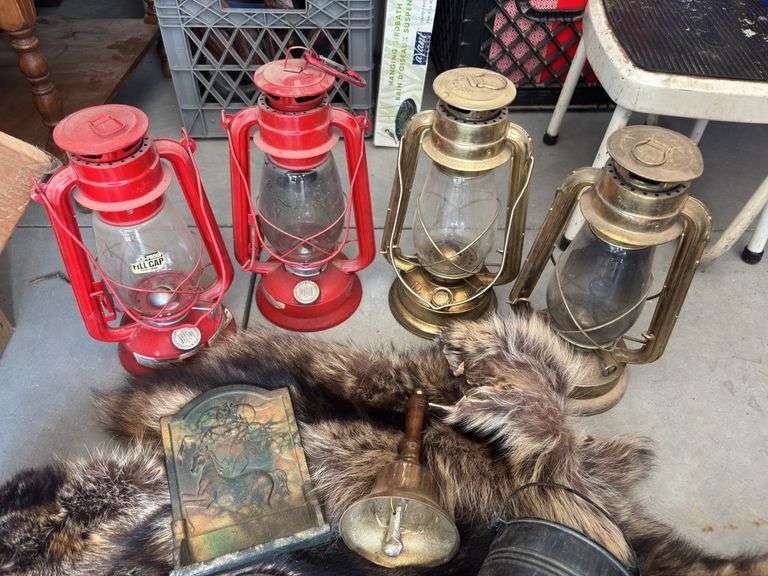 Four modern lanterns, brass bookends, brass school bell, raccoon hides