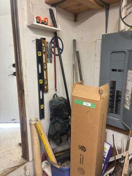 Corner of shop, including large box of new fluorescent bulbs