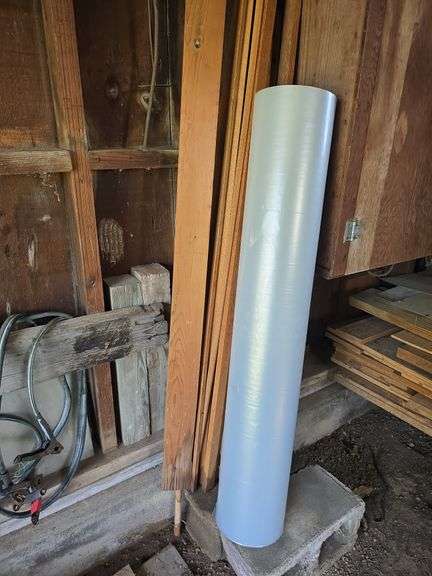 Car ramps, log chain, tire chains, scoop shovel, grease gun, large roll of plastic sheeting