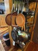 Cookware hanging on shelf - lots of skillets