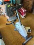 Weslo Pursuit 360R exercise bike and a pair of stainless steel dumbbells