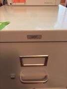 Two drawer letter file cabinet, HP LaserJet M140we printer and plastic stackable baskets
