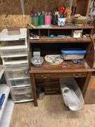 Small desk with lots of crafting items lots of tape, popsicle, sticks, rocks
