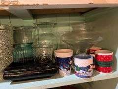 Contents of cupboard include vases, coffee mugs, TV lamp, etc