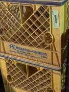 Plastic dairy crates and one wire carrier