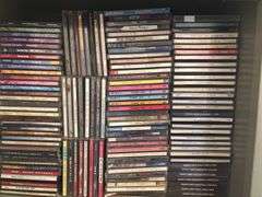 Two shelves full of DVDs and CDs