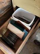 Four drawer file cabinet full of glass pieces