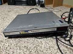 Panasonic DVD/CD player and CDs and storage tower