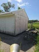 12' x 12' portable granary shed on skids, sitting on concrete pad, interior is lined for grain storage, buyer will have 30 days to remove