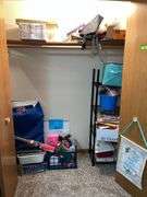 Metal shelf unit, education materials all in closet