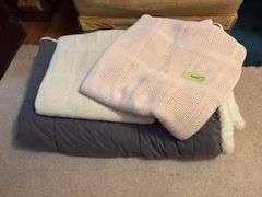 One warm fuzzy blanket and two sheet blankets