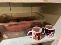 Contents of cupboard include vases, coffee mugs, TV lamp, etc