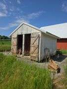 12' x 12' portable granary shed on skids, sitting on concrete pad, interior is lined for grain storage, buyer will have 30 days to remove