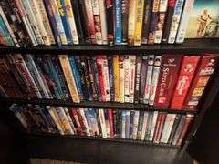 160+ DVDs and storage cabinet
