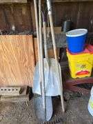 Car ramps, log chain, tire chains, scoop shovel, grease gun, large roll of plastic sheeting