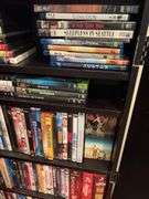 160+ DVDs and storage cabinet