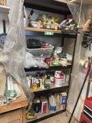 Metal shelving unit with lots of painting supplies