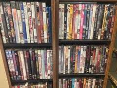 Two shelves full of DVDs and CDs