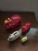 Three piggy banks and one pig with Grand Rapids Minnesota advertising
