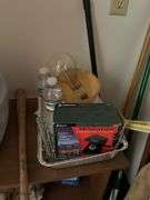 Small shelf with scale, cleaning stuff, battery charger, wooden ironing board, etc