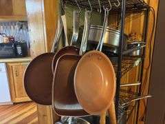 Cookware hanging on shelf - lots of skillets