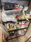 Metal shelving unit with lots of painting supplies