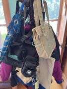 Heavy duty wooden hall tree loaded with bags and umbrellas Kinda cool, it has umbrella rests!!