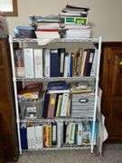 White metal shelf unit full of education materials BRING YOUR BOXES