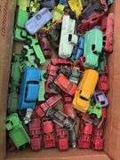 Box of toy cars, many appear to be Tootsie Toys