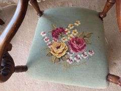 Antique oak platform rocker with needlepoint seat, veneer has small chip on back