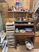 Small desk with lots of crafting items lots of tape, popsicle, sticks, rocks
