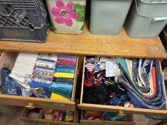 Eight drawer dresser, full of gift wrapping and party items plus large quantity of wrapping paper