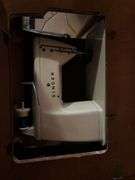 Singer sewing machine in table with bench and lots of additional sewing items in the bench