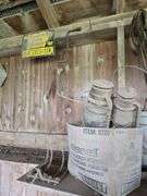 Oil, old gas cans, buckets, cast iron skillet, nails and more All on and under shelf