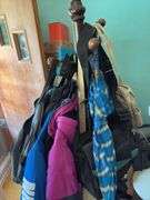 Heavy duty wooden hall tree loaded with bags and umbrellas Kinda cool, it has umbrella rests!!