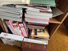 Small bookcase full of all kinds of reading materials
