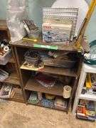 Three small shelves with assorted craft items