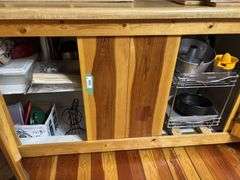 Lower cupboard contents in kitchen - bakeware, pans, colander, plasticware