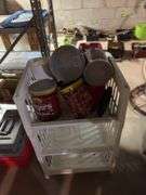 Metal shelving unit with contents, office chair, tool boxes and plastic stackable storage bins with empty coffee cans