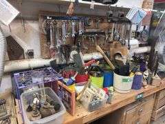 Large quantity of hand tools on top of bench