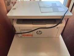 Two drawer letter file cabinet, HP LaserJet M140we printer and plastic stackable baskets