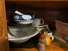 Two shelves of glassware - juice pitcher, soup bowls, cups, trays, china items