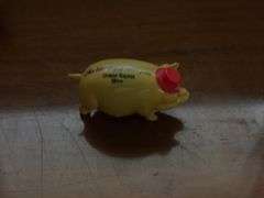 Three piggy banks and one pig with Grand Rapids Minnesota advertising
