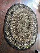 63x52 braided rug, see photos for condition Couple small holes