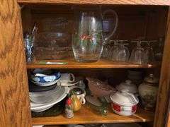 Two shelves of glassware - juice pitcher, soup bowls, cups, trays, china items