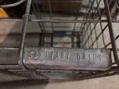Plastic dairy crates and one wire carrier